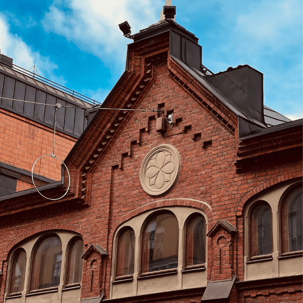 Brick building with decorative elements against a blue sky